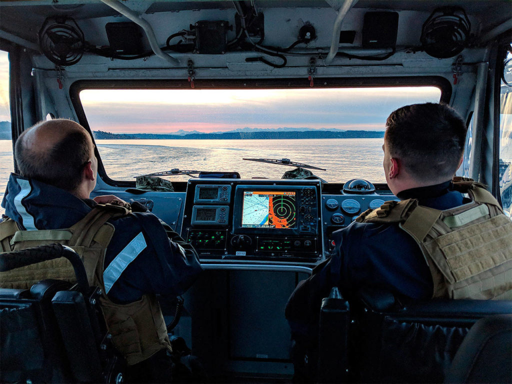 Petty Officers 3rd Class Brandon Soland and Kristoff Decker of U.S. Coast Guard Port Security Unit 313 in Everett participate in night tactic training on Feb. 11. (Petty Officer 1st Class Robert Kroll / U.S. Coast Guard)
