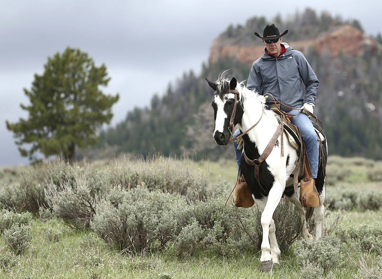 FILES - In this May 9, 2017, file photo, Interior Secretary Ryan Zinke rides in the Bears Ears National Monument with local and state representatives in Blanding, Utah. President Donald Trump will announce plans next week to shrink two sprawling Utah national monuments by nearly two-thirds, reversing actions taken by Democrat Barack Obama after a years-long push by tribal leaders and environmental groups. Leaked documents obtained by The Associated Press show that Trump plans to shrink Bears Ears National Monument by nearly 85 percent and reduce Grand Staircase-Escalante National Monument by almost half. (Scott G Winterton/The Deseret News via AP)                                Interior Secretary Ryan Zinke rides in the Bears Ears National Monument with local and state representatives in Blanding, Utah, in May last year. (Scott G Winterton/The Deseret News via AP, file)
