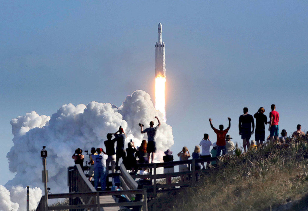 The crowd cheers at Playalinda Beach at Canaveral National Seashore in Florida, just north of the Kennedy Space Center, during the successful launch of the SpaceX Falcon Heavy rocket on Tuesday. (Joe Burbank/Orlando Sentinel via AP)
