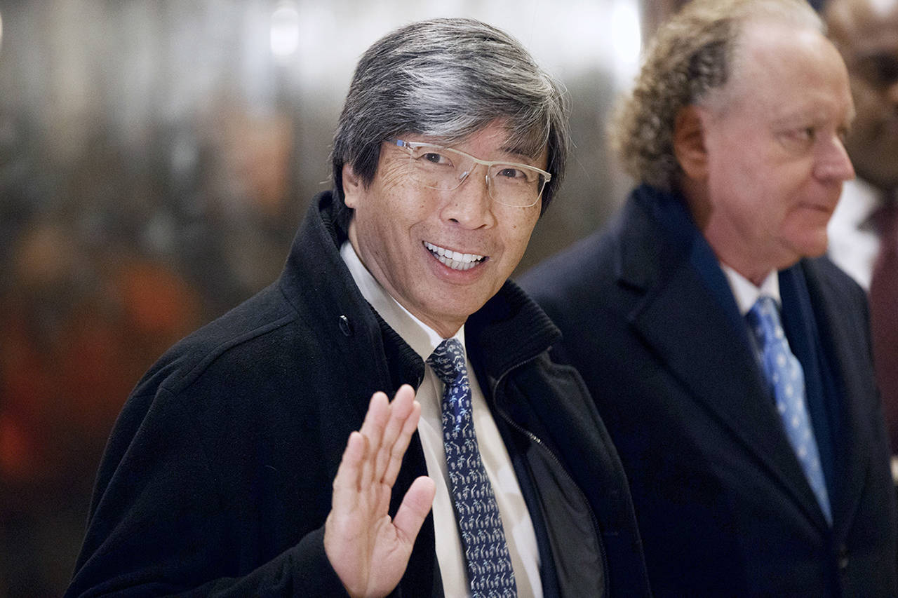 Pharmaceuticals billionaire Dr. Patrick Soon-Shiong waves as he arrives in the lobby of Trump Tower in New York for a meeting with President-elect Donald Trump in January. (AP Photo/Evan Vucci, File)