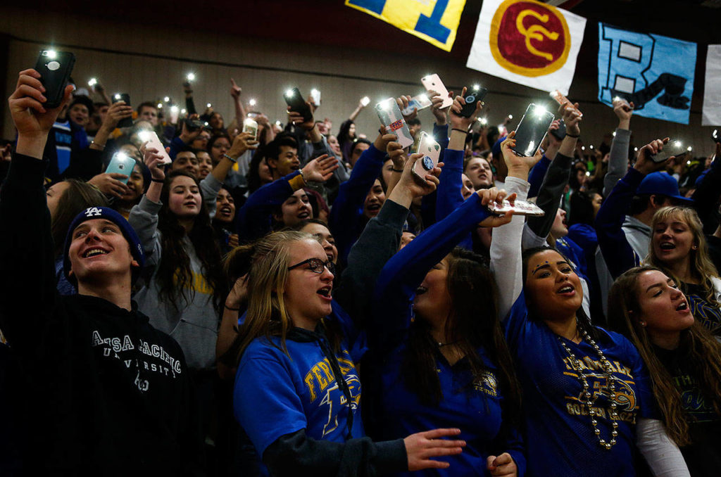 Ferndale High School students light things up early at Marysville Pilchuck High School on Tuesday morning after arriving for Interhigh with thousands of other students from more than three dozen schools around the region. (Dan Bates / The Herald)
