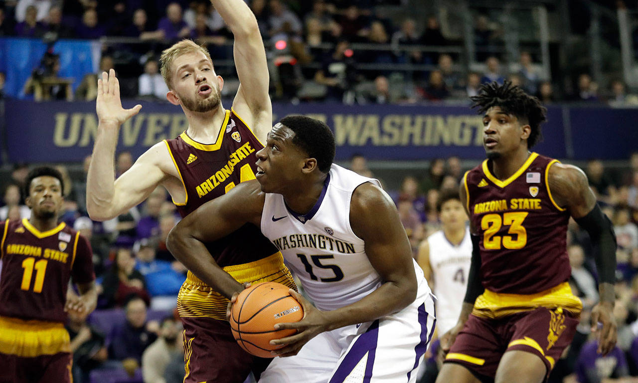 Washington forward Noah Dickerson (15) goes up for a shot as Arizona State’s Kodi Justice (left) and Romello White (23) defend during a game Feb. 1, 2018, in Seattle. (AP Photo/Ted S. Warren)