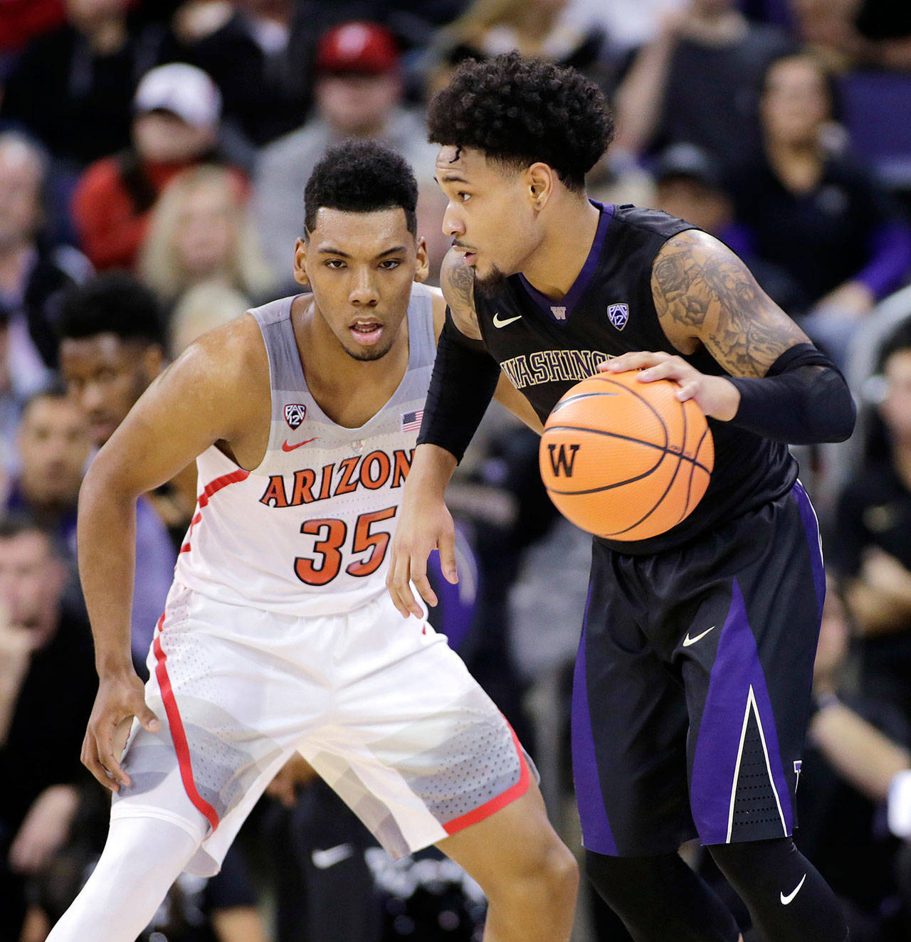 Washington’s David Crisp drives against Arizona’s Allonzo Trier during the Huskies 78-75 upset of the Wildcats on Feb. 3 in Seattle. (AP Photo/John Froschauer)