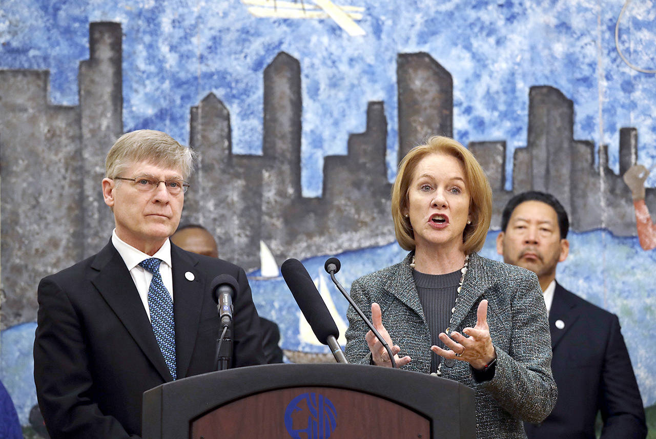 Seattle City Attorney Pete Holmes (left) looks on as Mayor Jenny Durkan speaks at a news conference Thursday, in Seattle, announcing plans for the city to move to vacate misdemeanor marijuana possession convictions. (AP Photo/Elaine Thompson)
