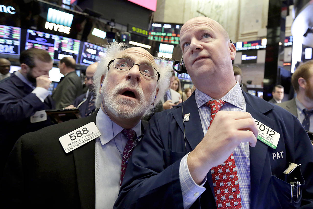 Traders Peter Tuchman (left) and Patrick Casey work on the floor of the New York Stock Exchange on Thursday. (AP Photo/Richard Drew)