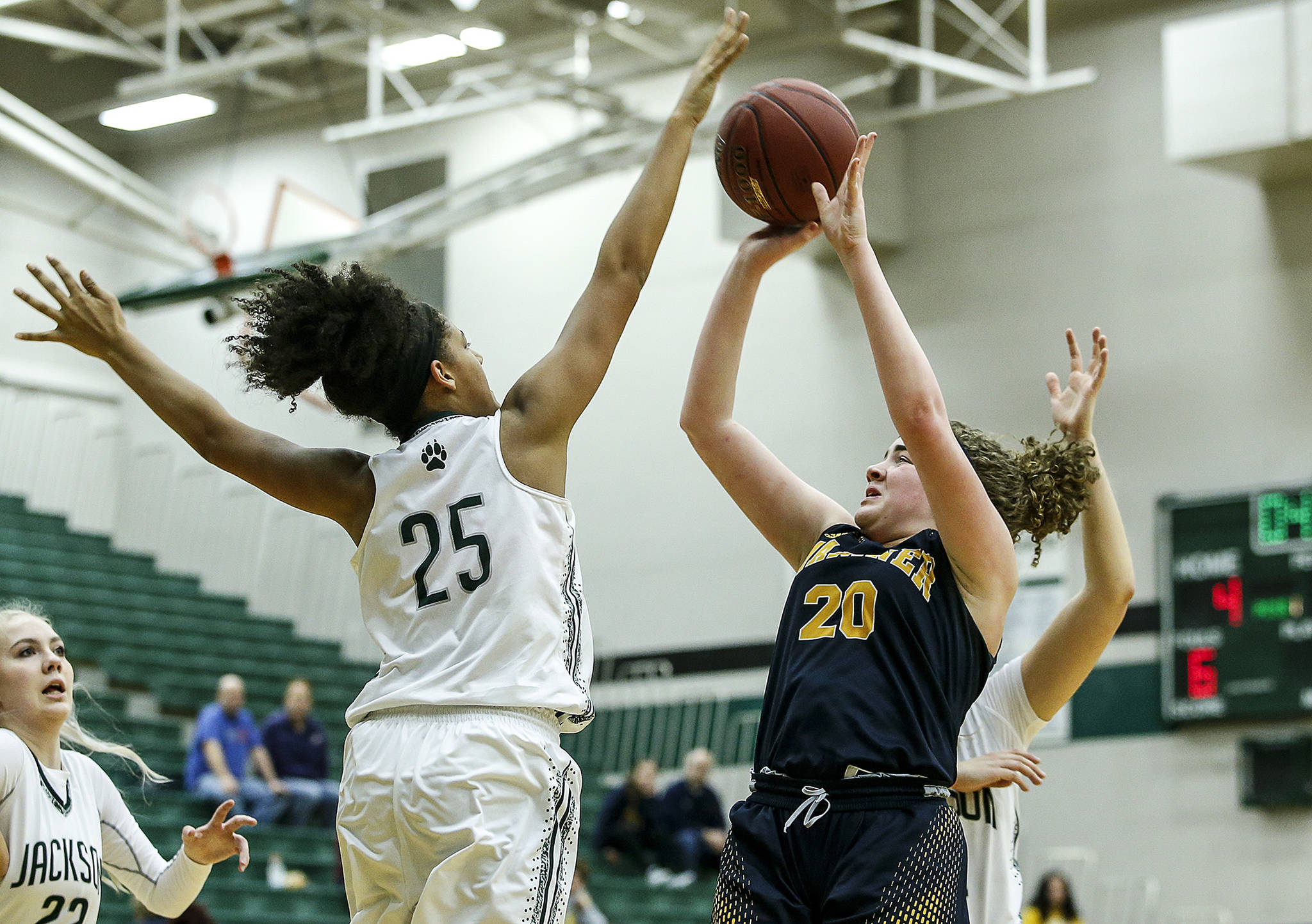 Mariner’s Taliyah Clark (20) takes a shot as Jackson’s Sydney Carter (25) defends during a playoff game on Feb. 8, 2018, at Jackson High School in Mill Creek. (Ian Terry / The Herald)