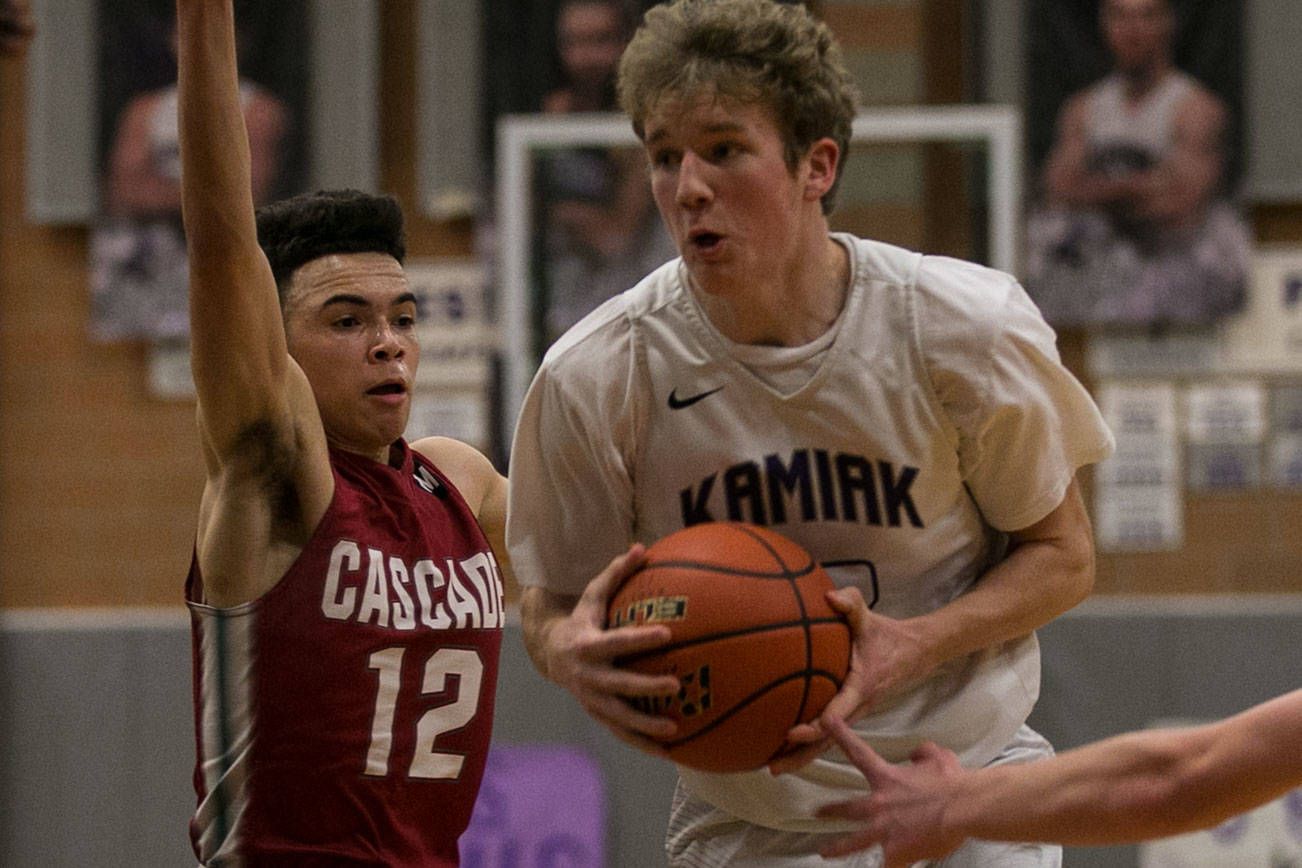 Kamiak’s Conner Fitzpatrick attempts a drive with Cascade’s Neco Taylor trailing Thursday night at Kamiak High School in Mukilteo on February 8, 2018. (Kevin Clark / The Daily Herald)
