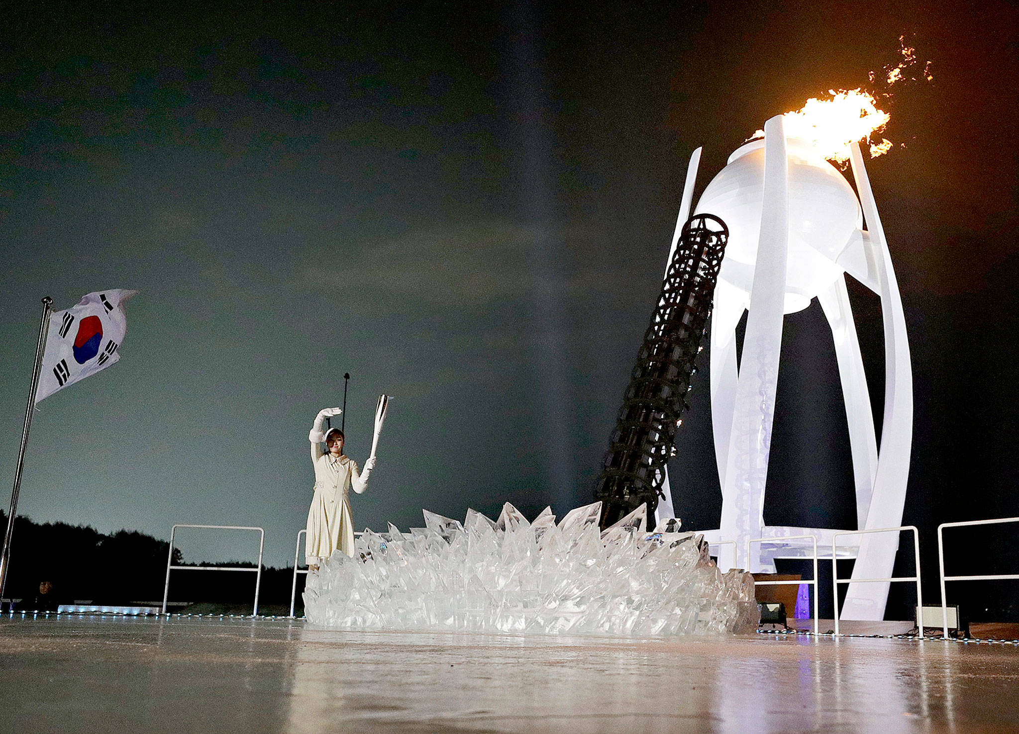 South Korean Olympic figure skating champion Yuna Kim lights the Olympic flame during the opening ceremony of the 2018 Winter Olympics in Pyeongchang, South Korea, on Friday. (AP Photo/David J. Phillip,Pool)