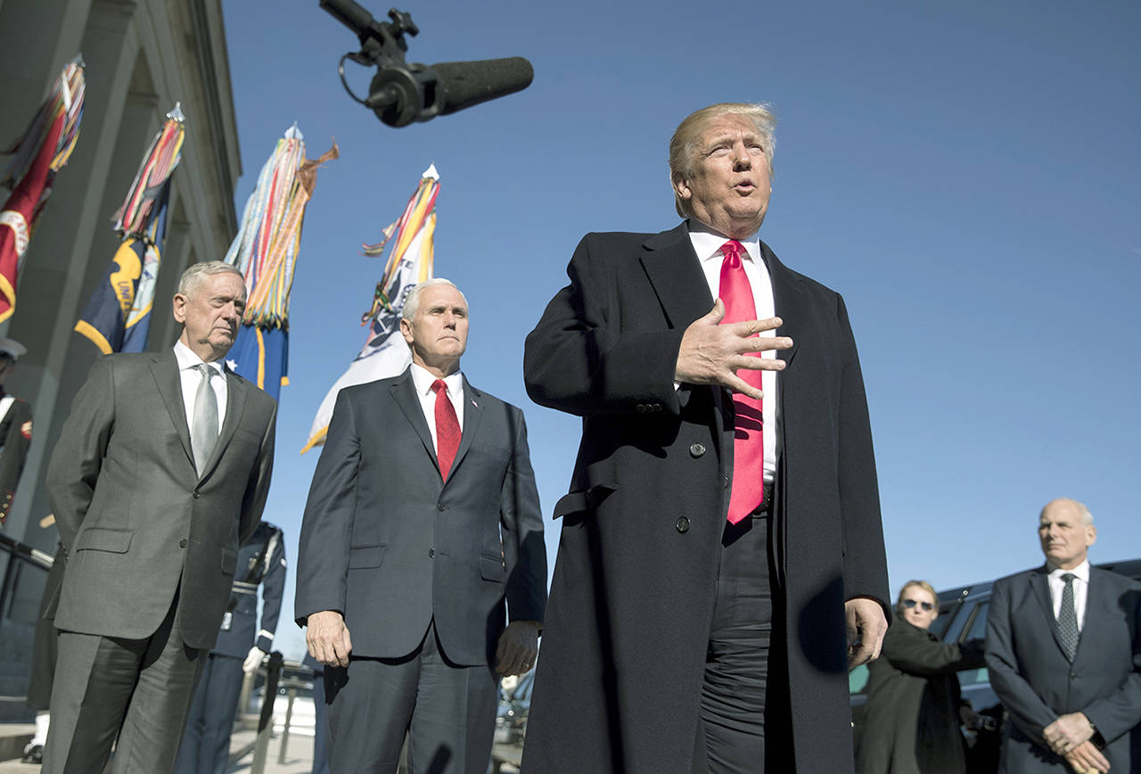 President Donald Trump, joined (from left) by Defense Secretary Jim Mattis, Vice President Mike Pence and White House Chief of Staff John Kelly speaks to the media as he arrives at the Pentagon on Jan. 18. (AP Photo/Carolyn Kaster, File)