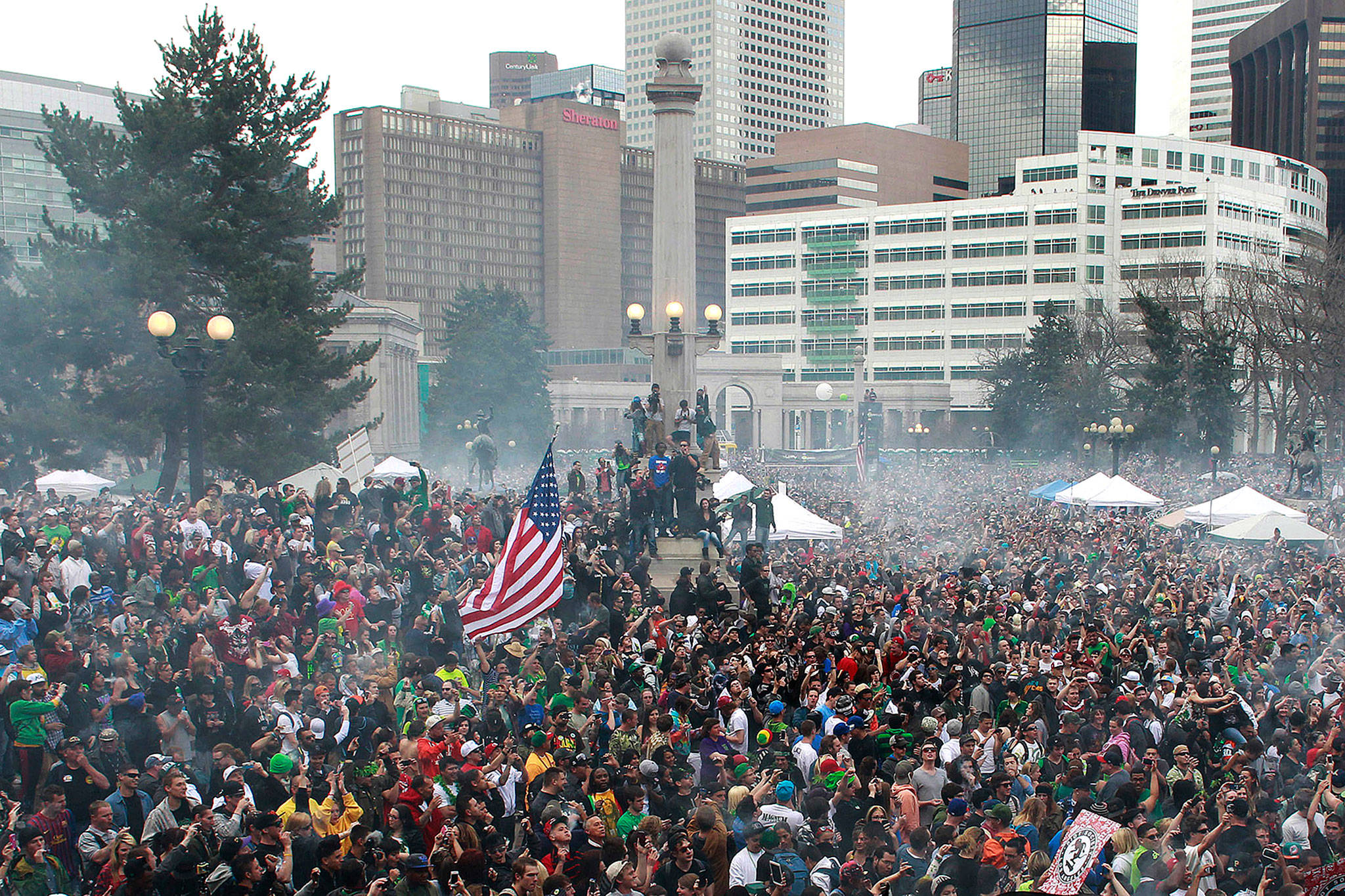 A crowd numbering in the tens of thousands smoke marijuana at the Denver 4/20 pro-marijuana rally at Civic Center Park in Denver in 2013. (AP Photo/Brennan Linsley, File)