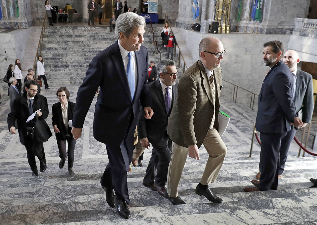 Former U.S. Secretary of State John Kerry walks through the Capitol rotunda in Olympia on Tuesday during a visit hosted by Gov. Jay Inslee to participate in meetings discussing the governor’s proposed tax on fossil fuel emissions. (Ted S. Warren / Associated Press)