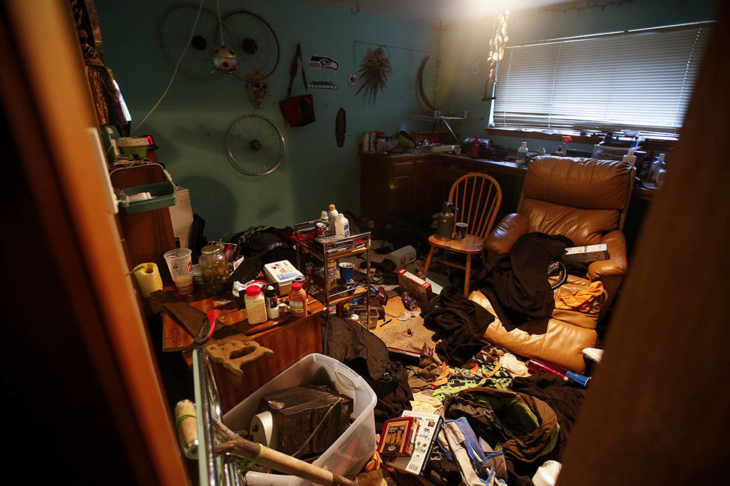 A room cluttered with garbage and various items is seen inside a home in Everett used by squatters in 2017. (Ian Terry / Herald file)
