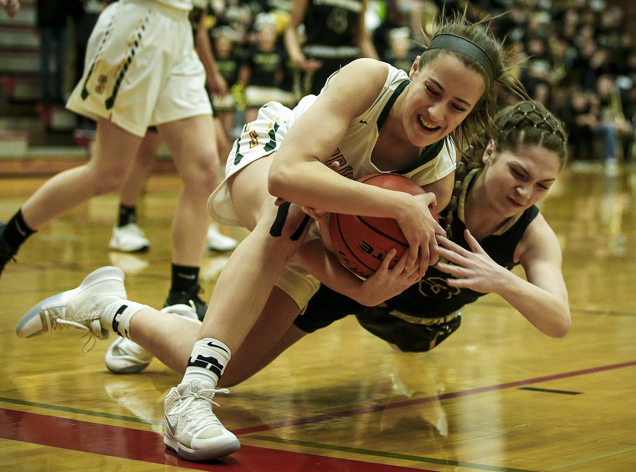 Shorecrest’s Julia Strand (left) battles for a loose ball with Lynnwood’s Rachel Walsh (right) during a game at Mountlake Terrace High School on Tuesday, Feb. 13. (Ian Terry / The Herald)