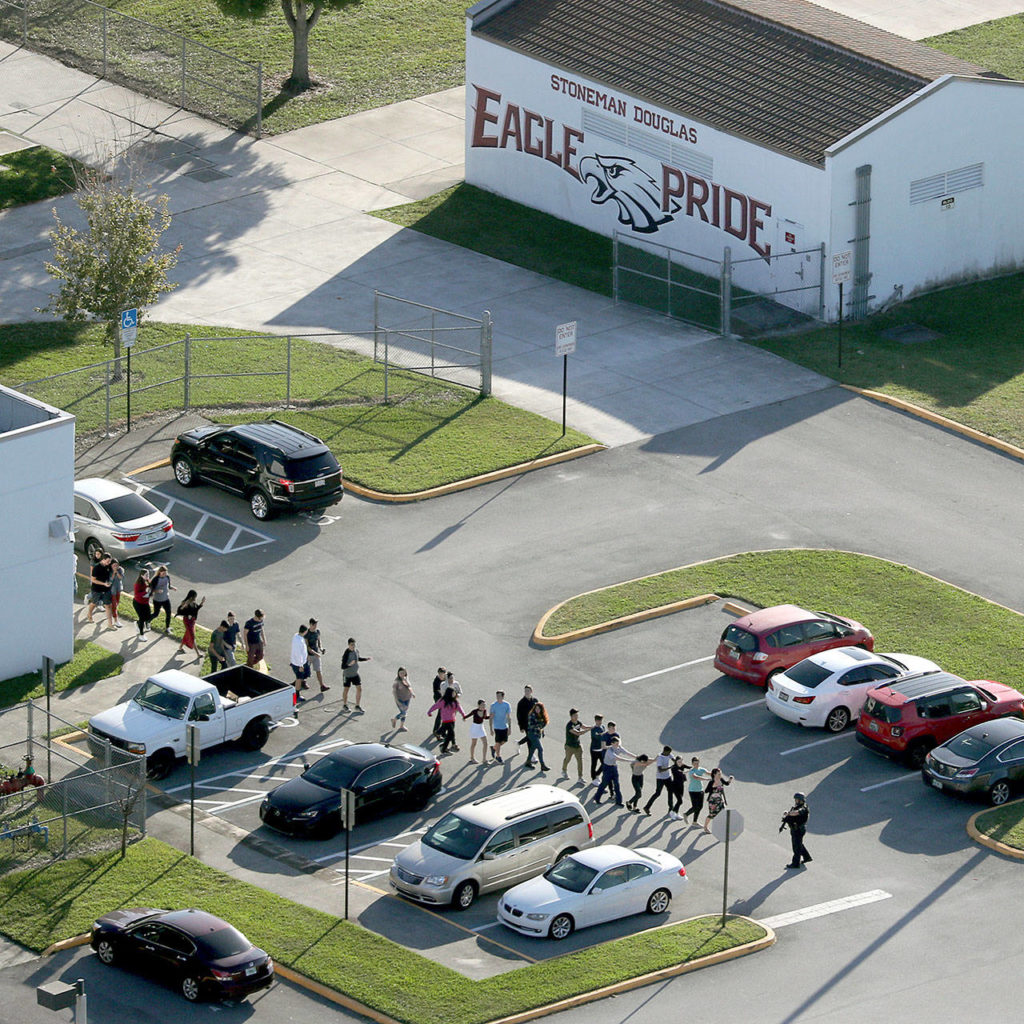 Students are evacuated by police from Marjorie Stoneman Douglas High School in Parkland, Florida, on Wednesday after a shooter opened fire on the campus. (Mike Stocker/South Florida Sun-Sentinel via AP) 
