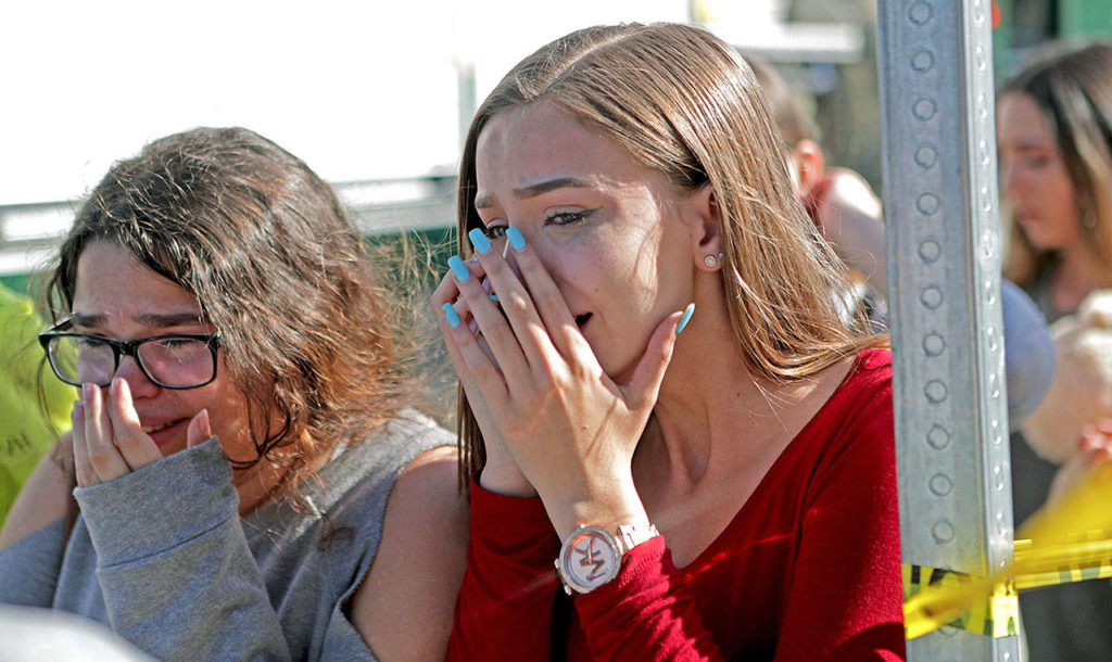 Students released from a lockdown are overcome with emotion following a shooting at Marjory Stoneman Douglas High School in Parkland, Florida, on Wednesday. (John McCall/South Florida Sun-Sentinel via AP)
