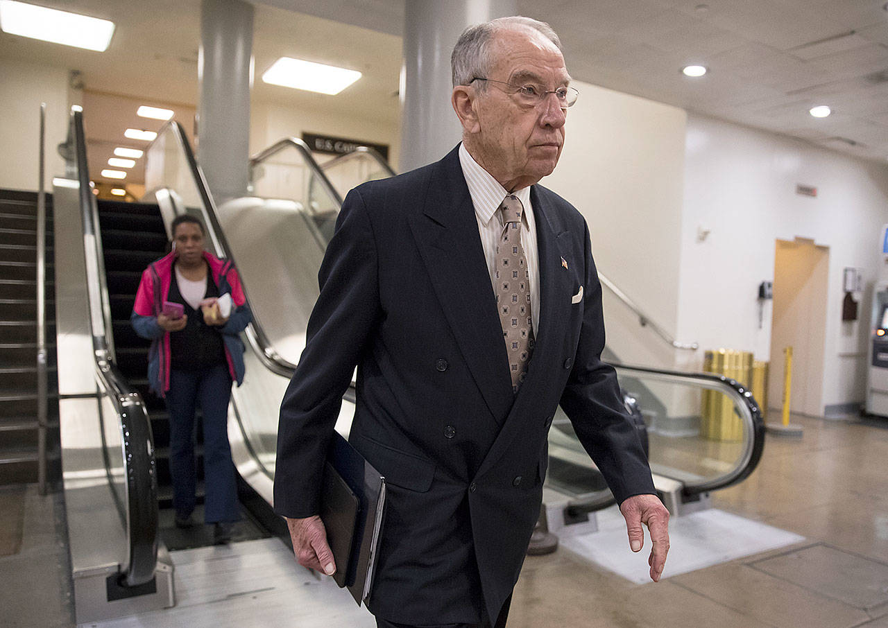 Senate Judiciary Committee Chairman Chuck Grassley, R-Iowa, walks through the Capitol amid debates in the Senate on immigration Wednesday. (AP Photo/Scott Applewhite)