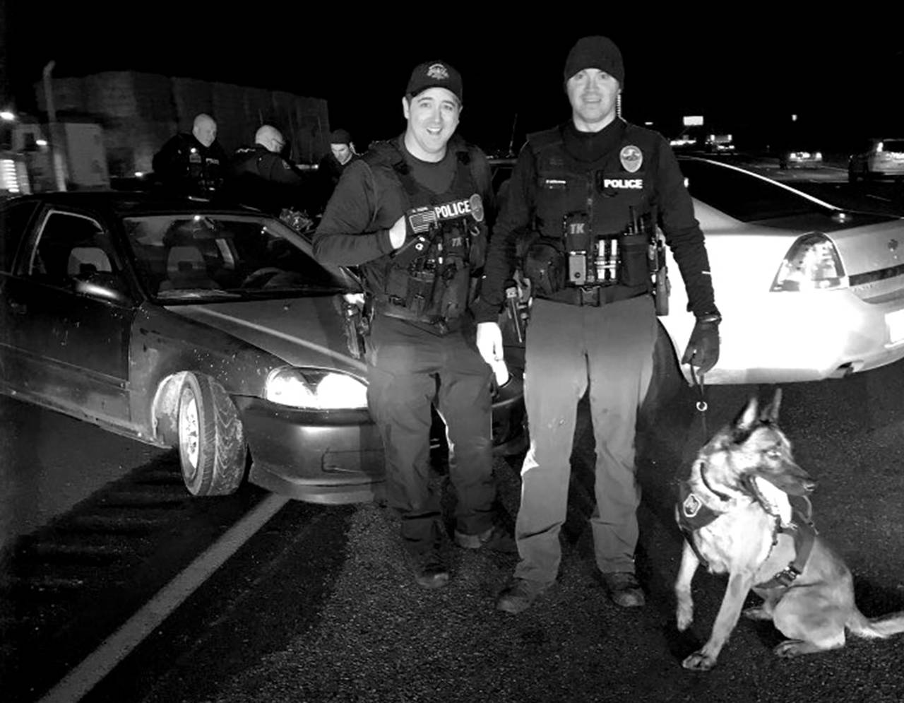 Marysville police officers Mike Young (from left), Brad Smith and K-9 Steele arrested a man Wednesday after he led them on a high-speed, wrong-way chase onto I-5. (Marysville Police Department)