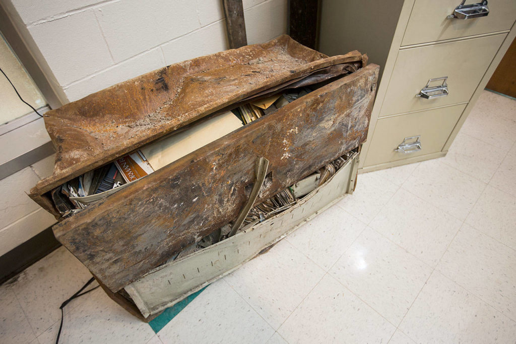 A burned safe sits in a corner at Everett Office Furniture on Jan. 25 in Everett. The safe fell from the second floor and all the paperwork inside survived the fire, allowing the company to stay in business. (Andy Bronson / The Herald)
