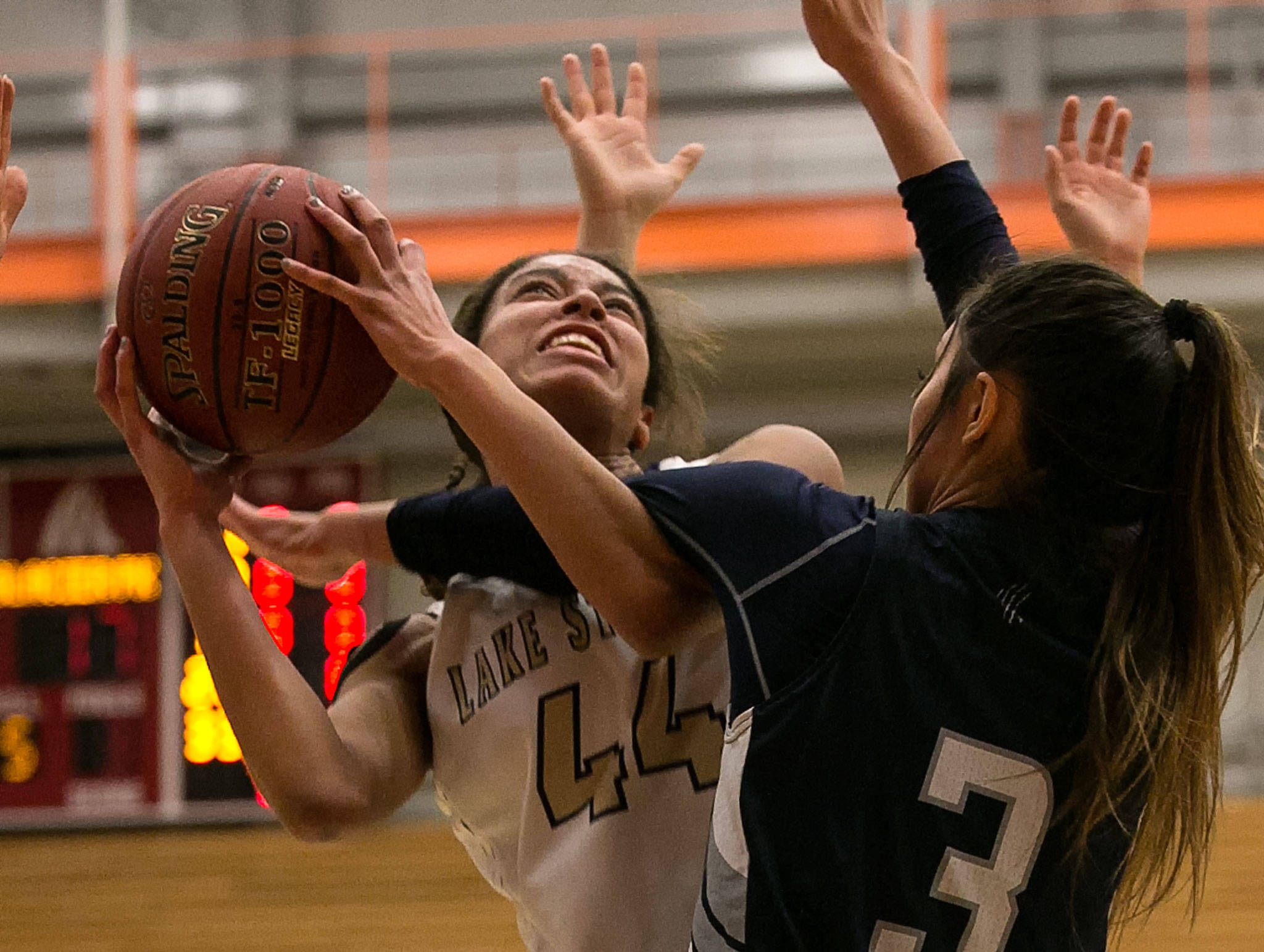 Lake Stevens’ Kylee Griffen (left) attempts a shot with Glacier Peak’s Makayla Guerra defending during the 4A district championship on Feb. 15, 2018, at Everett Community College. (Kevin Clark / The Herald)