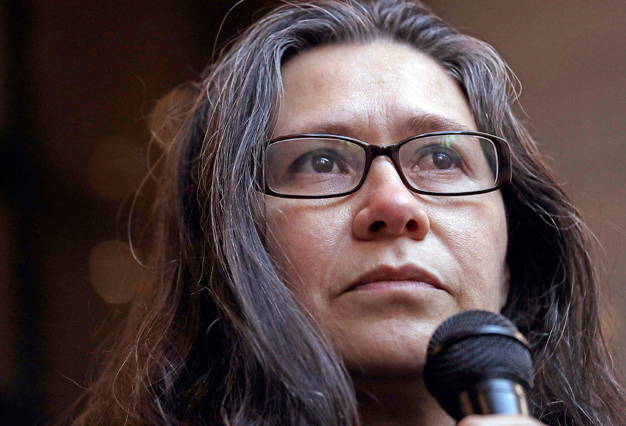 Maru Mora-Villalpando acknowledges supporters surrounding her at a news conference Jan. 16 announcing that the longtime activist for illegal immigrants in the Northwest says she herself is now facing deportation, in Seattle. (Elaine Thompson / Associated Press file)