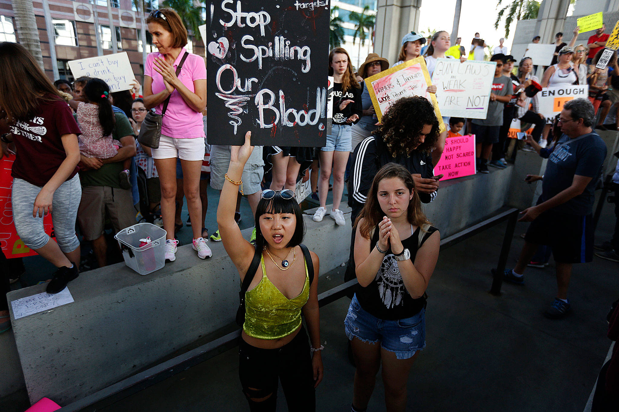 Marylene Dinliana, 18, holds a sign that reads “Stop Spilling Our Blood” during a protest against guns on the steps of the Broward County Federal courthouse in Fort Lauderdale, Florida, on Saturday. (AP Photo/Brynn Anderson)