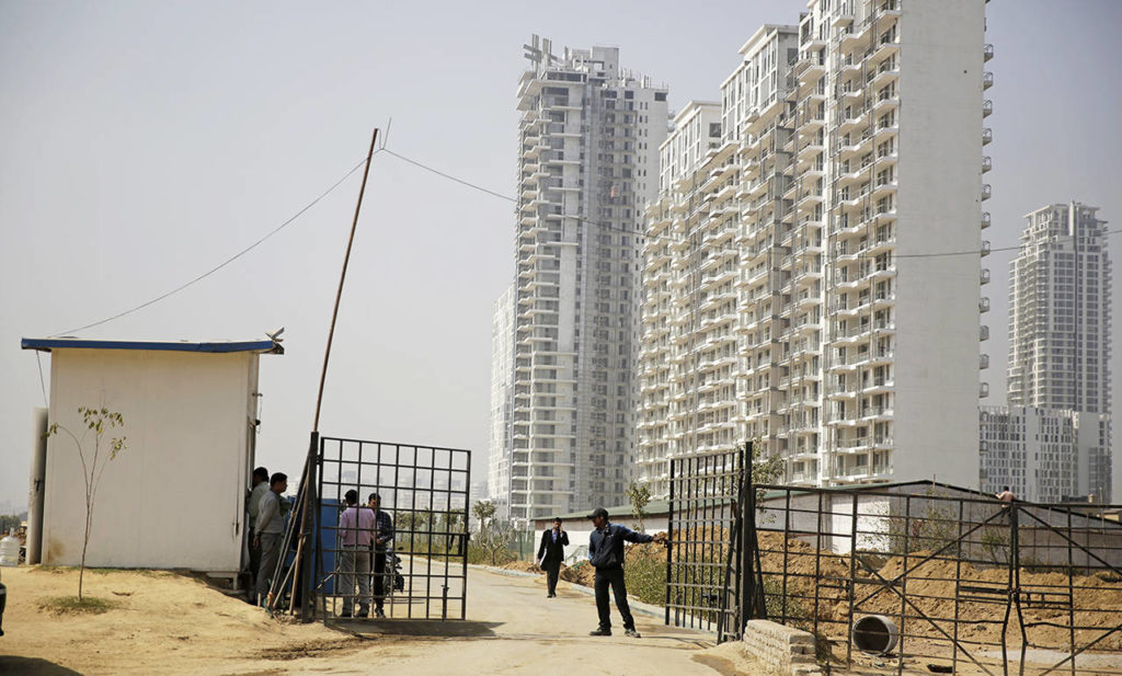 A security man closes a gate leading to the proposed site for the Trump Towers in Gurgaon, a suburb of New Delhi, India, on Tuesday. (AP Photo/Altaf Qadri)
