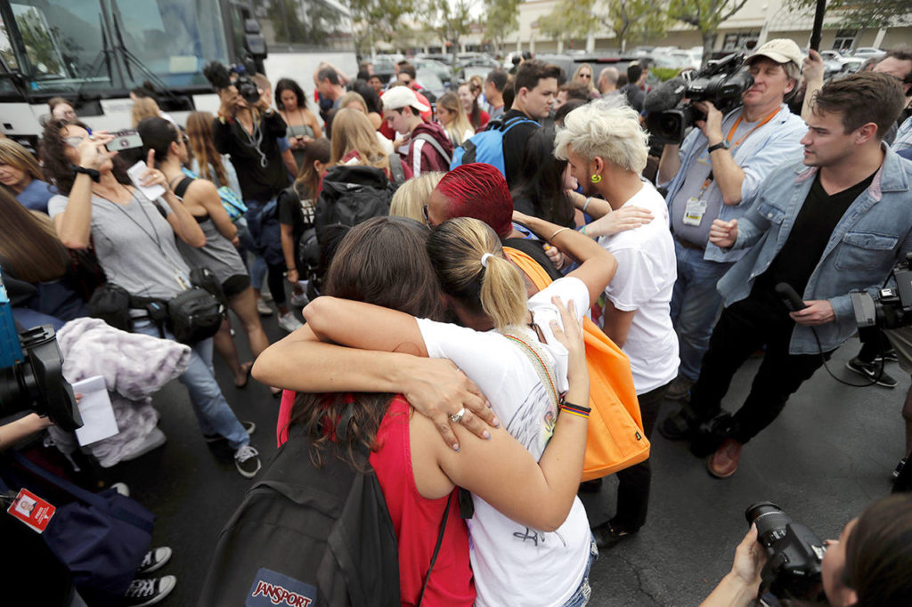 Students from Stoneman Douglas High School hug survivors of the Pulse nightclub shooting before boarding buses in Parkland, Florida, on Tuesday. (Associated Press)
