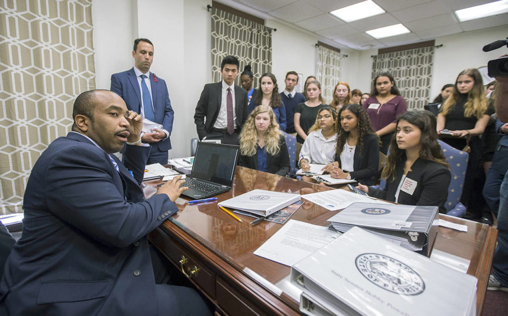 Sen. Bobby Powell talks with survivors from Marjory Stoneman Douglas High School and other students from Broward County high schools in his office at the Florida Capital in Tallahassee, Florida, on Tuesday. (AP Photo/Mark Wallheiser)
