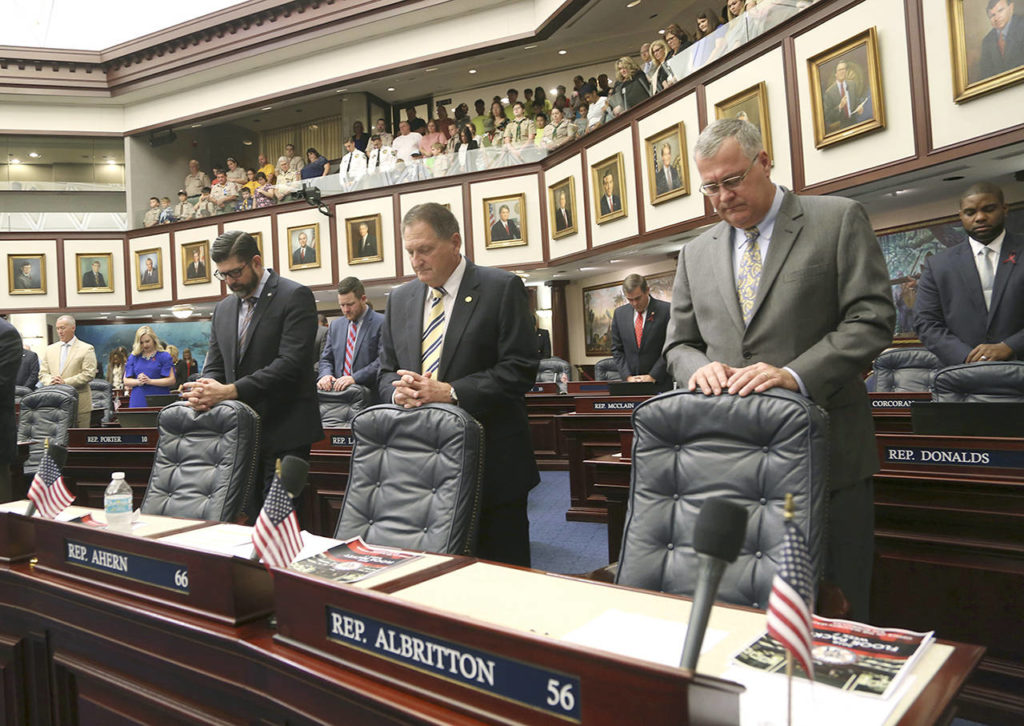 From left, Florida House members Rep. Manny Diaz, Jr., R- Hialeah, Rep. Larry Ahern, R- Seminole, and Rep. Ben Albritton, R- Wauchula, all stand in silence on Tuesday in Tallahassee with other members of the Florida House in memory of the individuals who will killed during a school shooting at Marjory Stoneman Douglas High School in Parkland, Florida. (Scott Keeler/Tampa Bay Times via AP)
