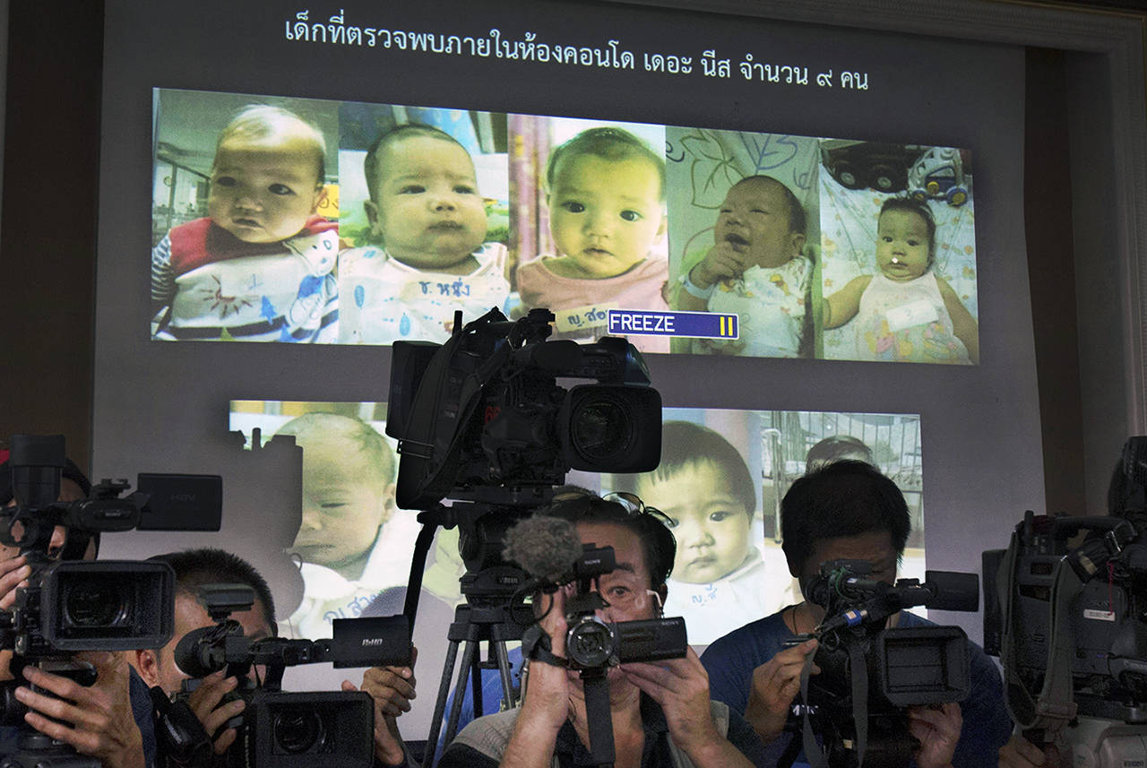 In this 2014 photo, the media attend a press briefing where Thai police display projected pictures of surrogate babies born to a Japanese man who is at the center of a surrogacy scandal during a press conference at the police headquarters in Chonburi, Thailand. (AP Photo/Sakchai Lalit, File)
