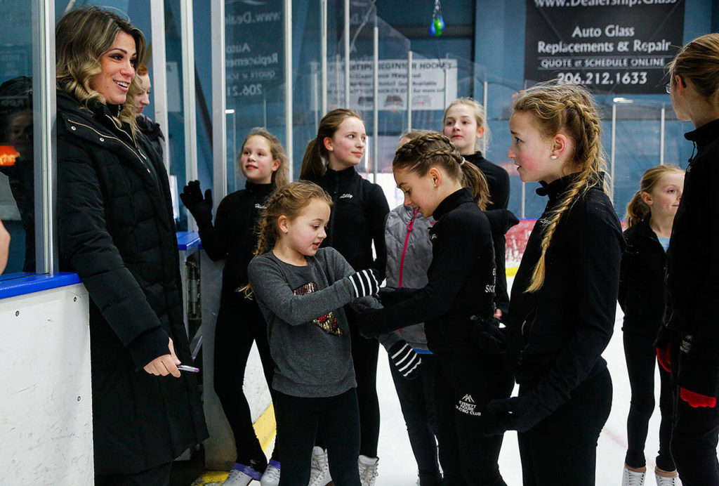 Coach Susannah Hall McAllister talks with Logan Stephenson (long pigtails) during a class Thursday at Everett’s community ice rink. (Dan Bates / The Herald)
