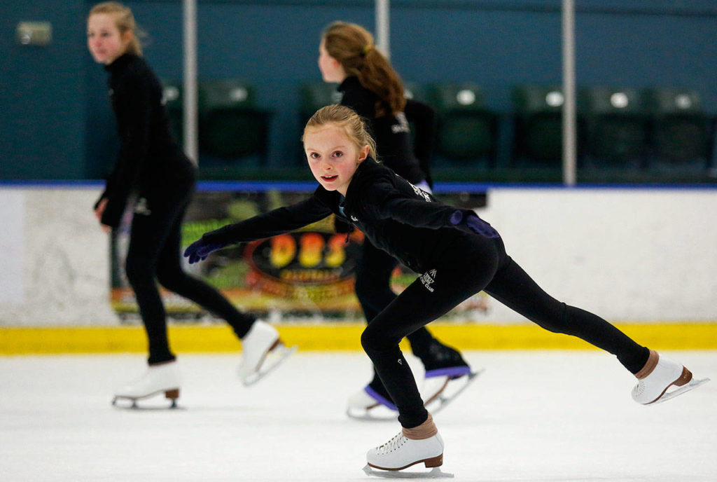 Ashley Stulc glides past fellow skating club members as while working out Thursday in Susannah Hall McAllister’s Everett Figure Skating Class. (Dan Bates / The Herald)
