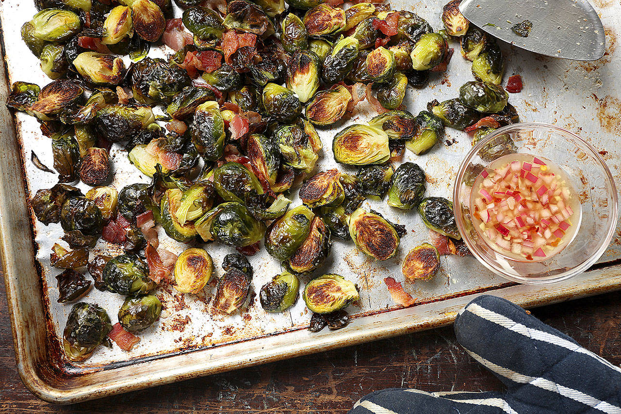 Roasted Brussels sprouts with bacon are served with a simple sweet and sour vinaigrette. (Abel Uribe/Chicago Tribune)