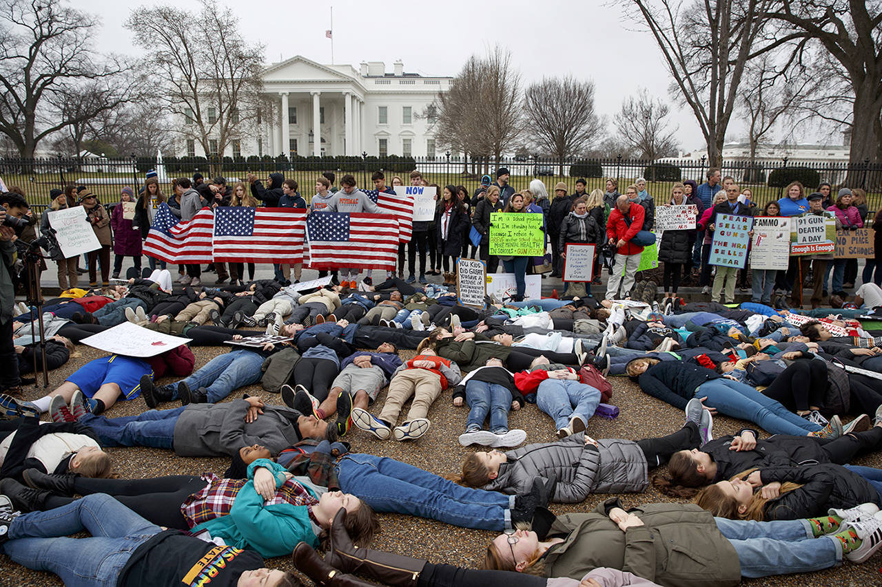 Demonstrators participate in a “lie-in” during a protest in favor of gun control reform in front of the White House on Monday in Washington. (AP Photo/Evan Vucci)