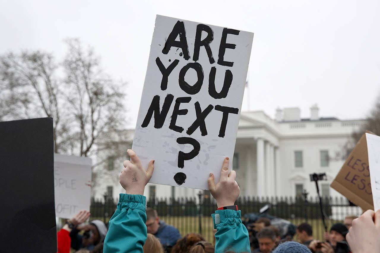 Demonstrators hold signs during a protest in favor of gun control reform in front of the White House on Monday in Washington. (AP Photo/Evan Vucci)