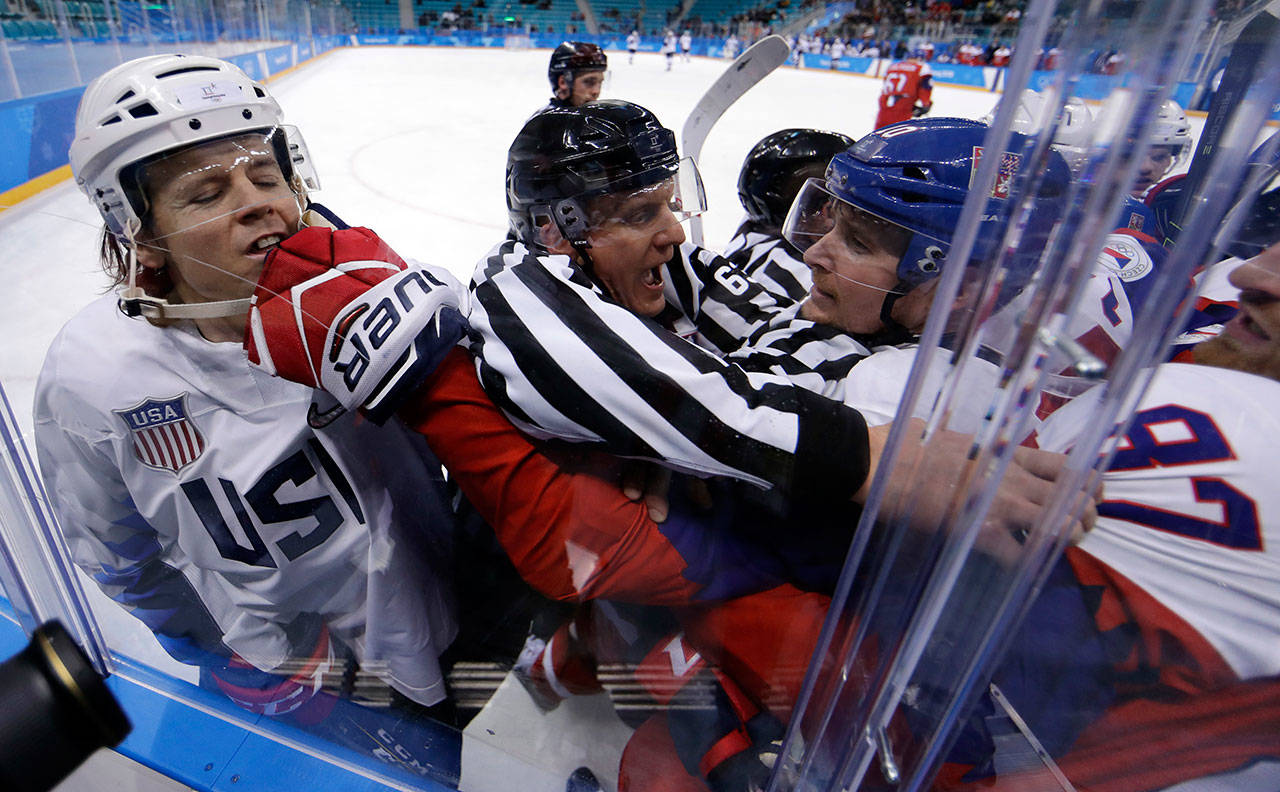 Referees break up a fight between players from the the United States and the Czech Republic during the first period of Wednesday’s quarterfinal game in Gangneung, South Korea. (AP Photo/Matt Slocum)