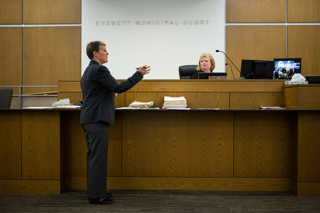 Leslie Tidball talks with Judge Laura Van Slyck during Jail Calendar at the Everett Municipal Court in Everett. (Andy Bronson / The Herald)
