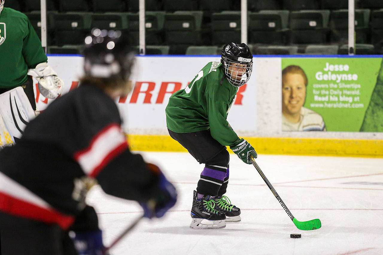 Leslie Tidball, second from right, practices with the Snohomish County Women’s Ice Hockey team at the main rink at Angel of the Winds Arena in Everett. (Andy Bronson / The Herald)