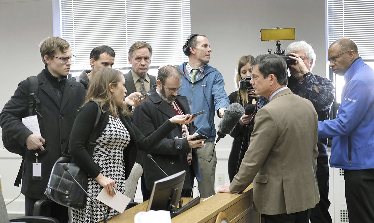 Reporters talk with Sen. Mark Miloscia, R-Federal Way (third from right), following a joint work session of the Senate and House State Government Committees on Thursday at the Capitol in Olympia. The session was held to discuss a bill filed Wednesday by lawmakers who want to circumvent a recent court ruling finding them fully subject to the state’s public disclosure laws. (AP Photo/Ted S. Warren)