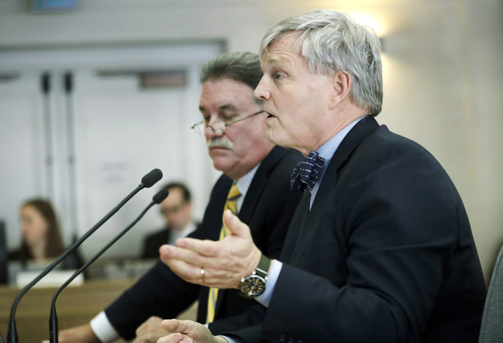 Rowland Thompson (right), executive director of Allied Daily Newspapers of Washington, testifies during a joint work session of the Senate and House State Government Committees on Thursday at the Capitol in Olympia. (AP Photo/Ted S. Warren)
