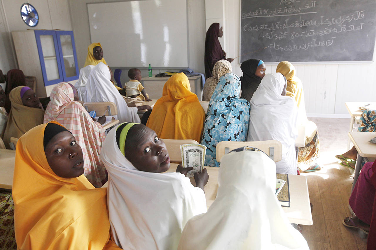 In this Dec. 2015 photo, children displaced by Boko Haram during an attack on their villages receive lectures in a school in Maiduguri, Nigeria. (AP Photo/Sunday Alamba, File)