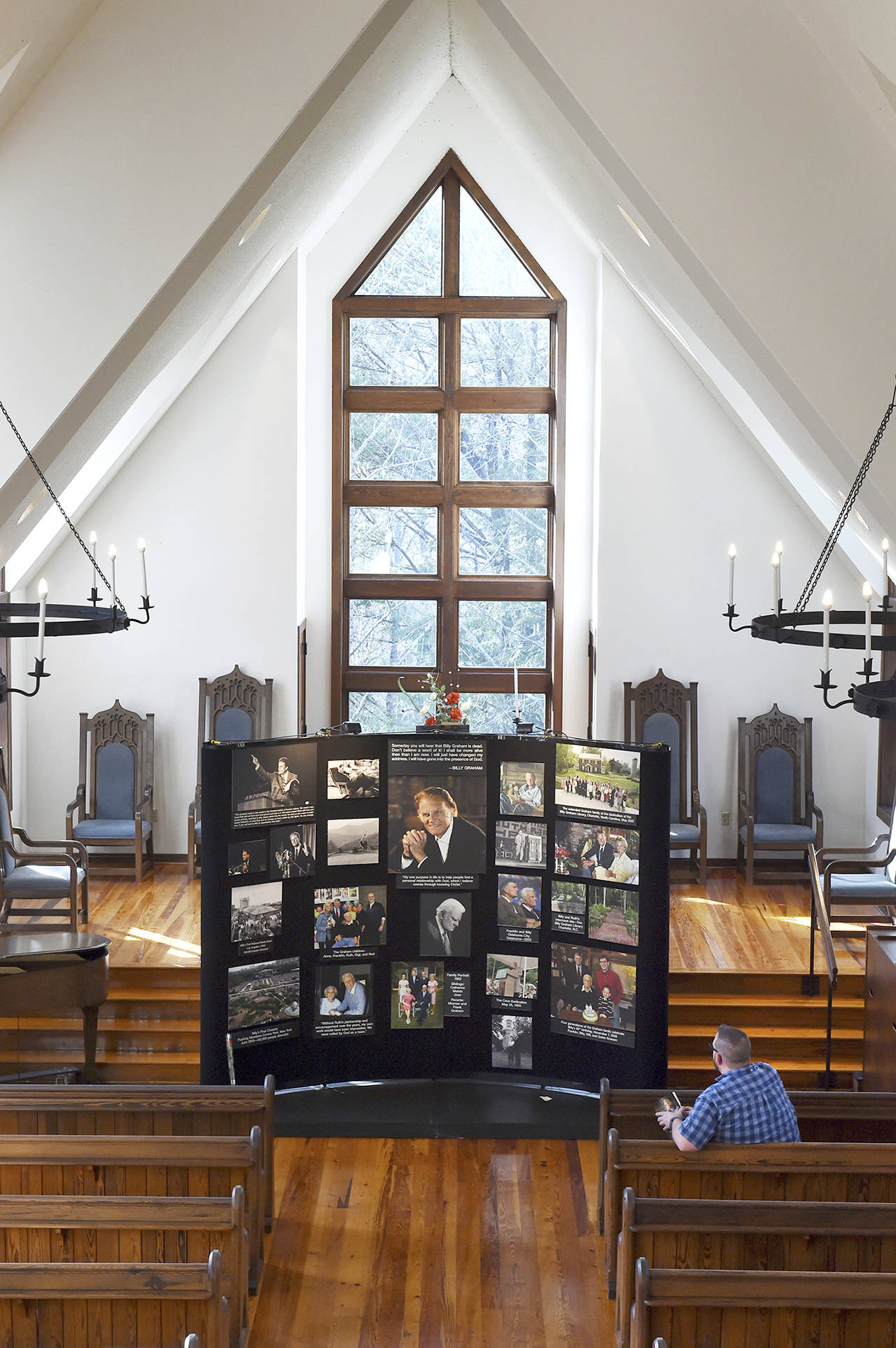 Jeremiah Chapman of Hillsborough, N.C., sits in a pew inside the chapel at the Billy Graham Training Center at the Cove to view a memorial display in honor of Graham on Wednesday, Feb. 21, 2018 in Asheville, NC. Graham, the world’s best-known evangelist, died at his home in Montreat, N.C. on Wednesday, his organization said. He was 99. (AP Photo/Kathy Kmonicek)