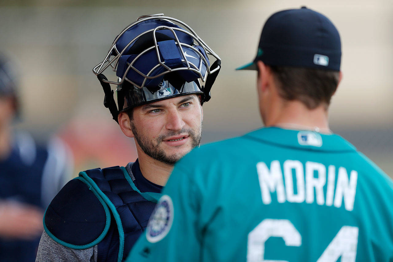 Mariners catcher Mike Zunino (left) talks with relief pitcher Mike Morin during a spring training workout on Feb. 19, 2018, in Peoria, Ariz. (AP Photo/Charlie Neibergall)