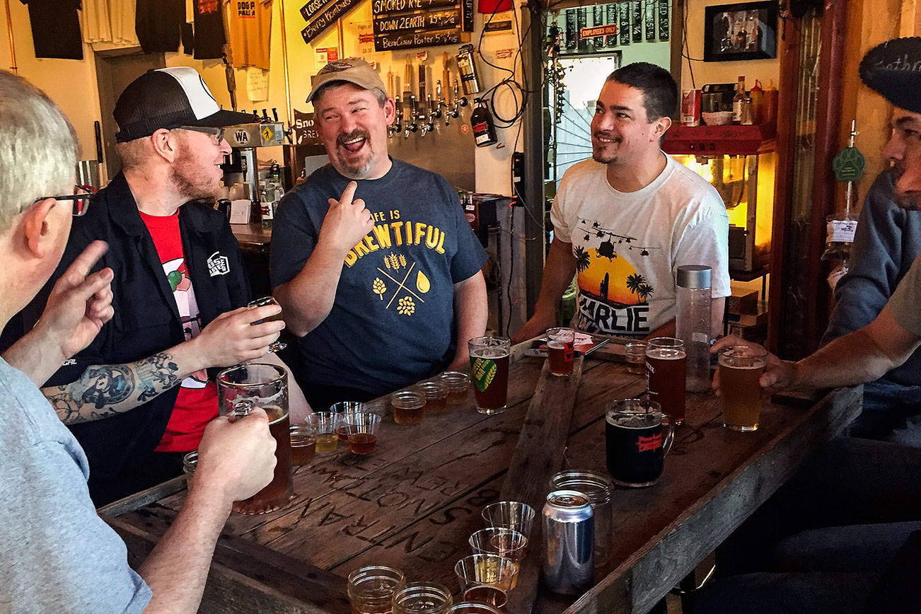 Brewers (from left) Jack Hatley, Nate McLaughlin, Kirk Hilse, Frank Sandoval, John Worthen, Cole Rinehardt and Don Worthen celebrate their recent brewing accomplishment at SnoTown Brewery. The five brewers, who all recently had their breweries close, each made a special beer with Sandoval for Saturday’s Washington Beer Open House. (Photo by Aaron Swaney)