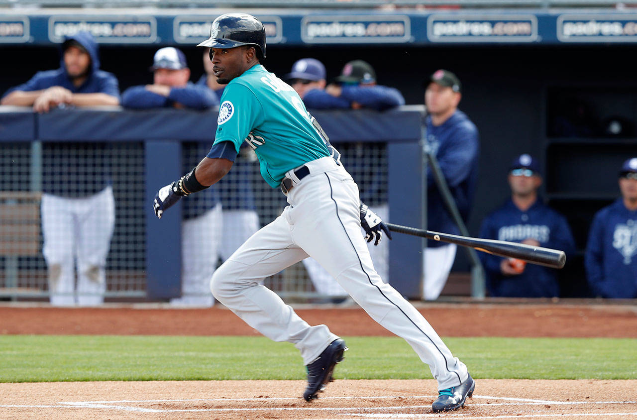 Seattle’s Dee Gordon hits a double during the first inning of Friday’s game in Peoria, Ariz. (AP Photo/Charlie Neibergall)