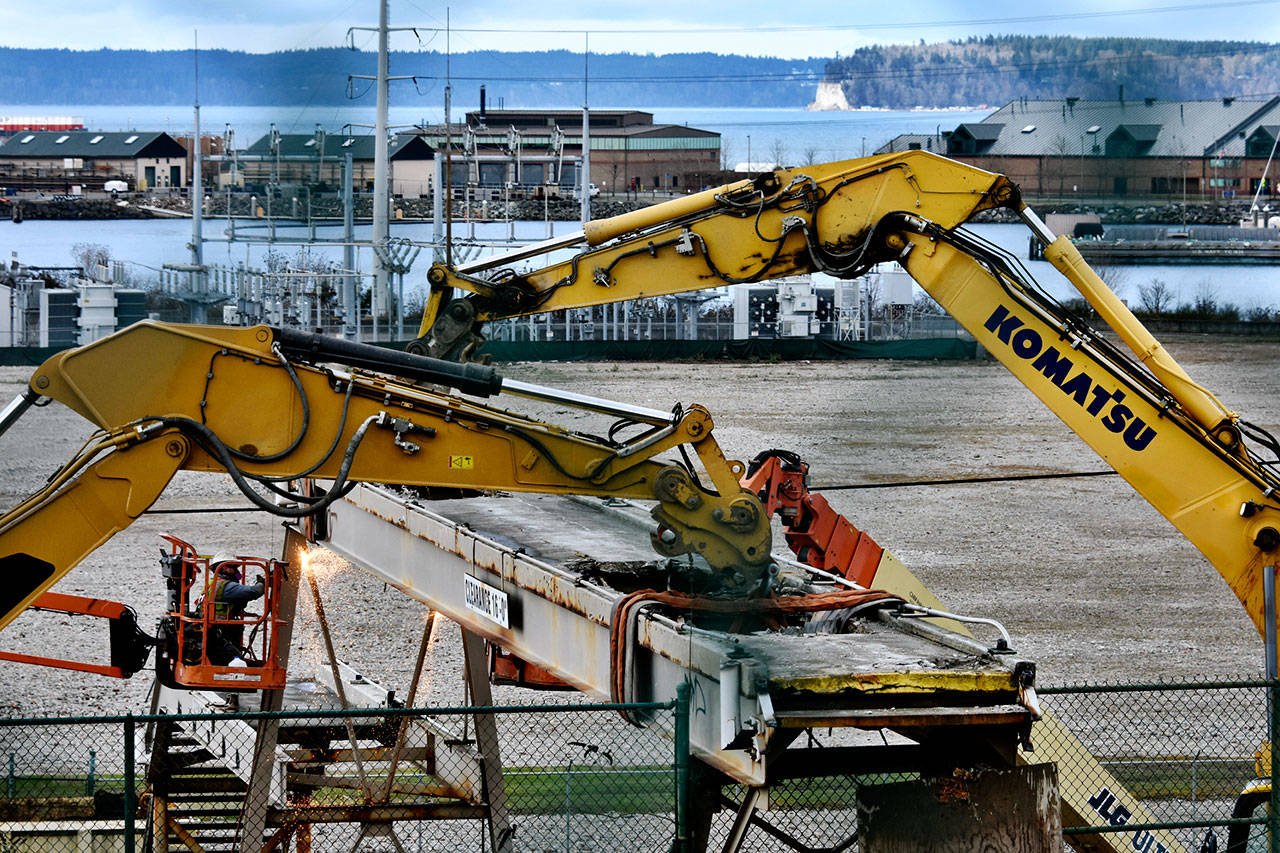 Contractors tear down a pedestrian bridge over West Marine View Drive Saturday. The bridge once carried workers to the Kimberly-Clark plant. (Caleb Hutton / The Herald)