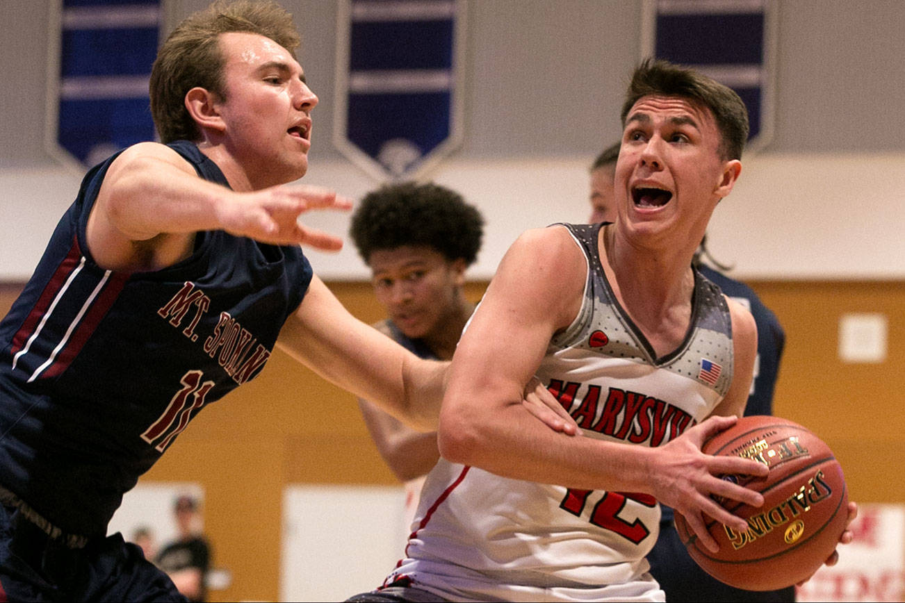 Marysville-Pilchuck’s Josiah Gould attempts a drive with Mount Spokane’s Jerry Twenge Saturday afternoon at North Creek High School in Bothell on February 24, 2018. (Kevin Clark / The Daily Herald)