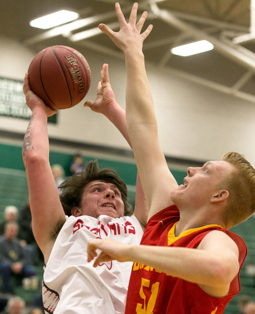 Stanwood’s Mitch Jones attempts a shot over Kamiakin’s Kyson Rose during a regional playoff game Saturday afternoon at Jackson High School in Mill Creek. (Kevin Clark / The Herald)
