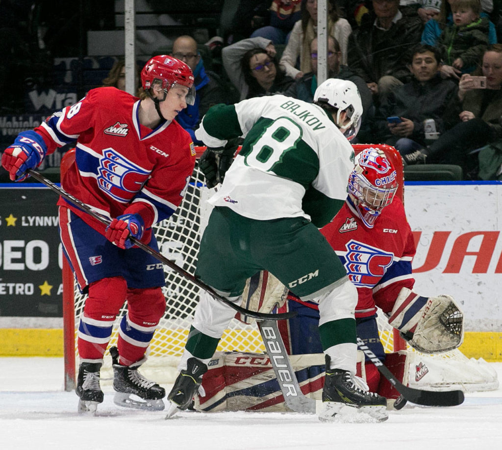 Everett’s Patrick Bajkov works the crease with Spokane’s Filip Kral (left) and Spokane’s Donovan Buskey defending at Angel of the Winds Arena Sunday afternoon in Everett on February 25, 2018. (Kevin Clark / The Daily Herald)
