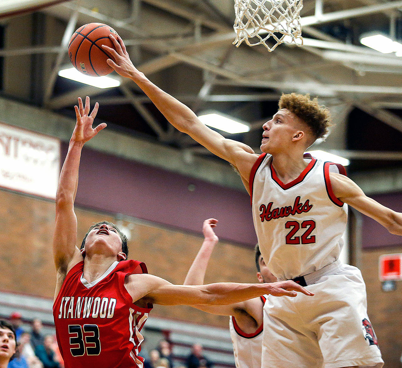 Mountlake Terrace is used to playing against schools with higher enrollment numbers. It didn’t trip them up during conference play, as evidenced by their rout of Stanwood earlier this season, when Khyree Amrstead (22) blocked a shot attempt by Stanwood’s Nate Kummer (33) on Tuesday, Jan. 30. (Ian Terry / The Herald)
